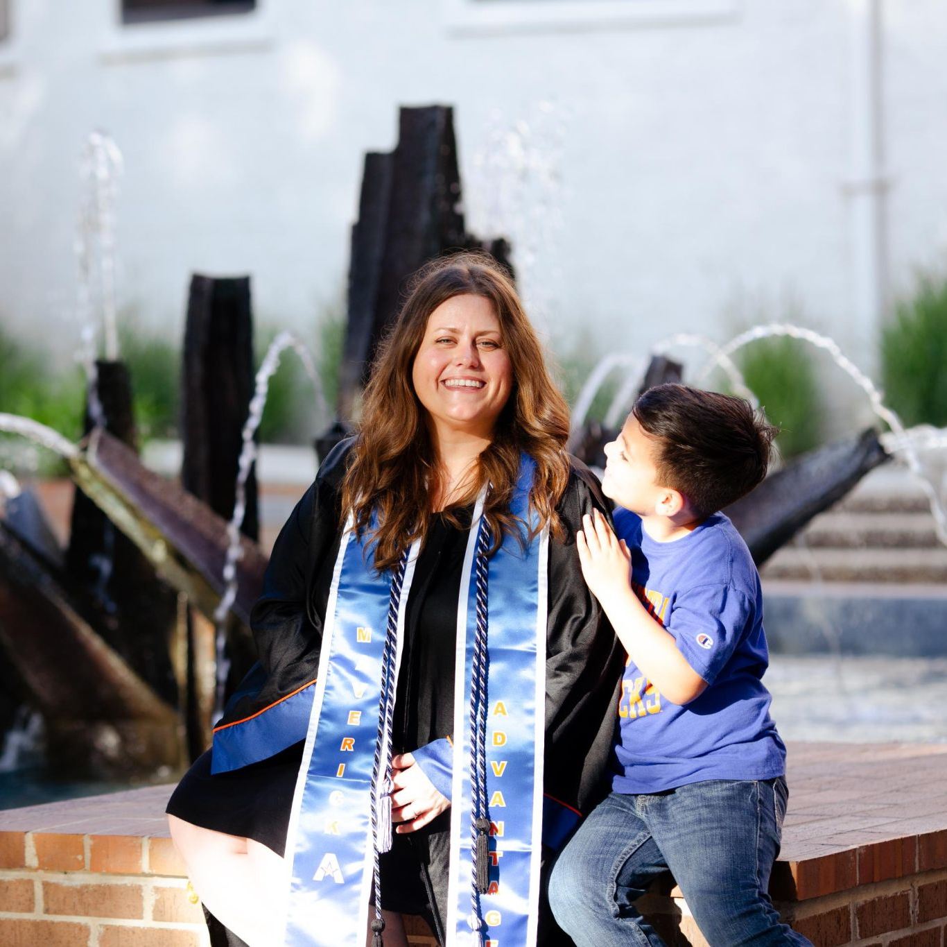 Photo of single mom graduating with child