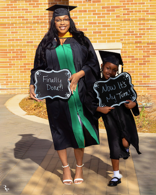 Photo of single mom graduate in gown and cap with child