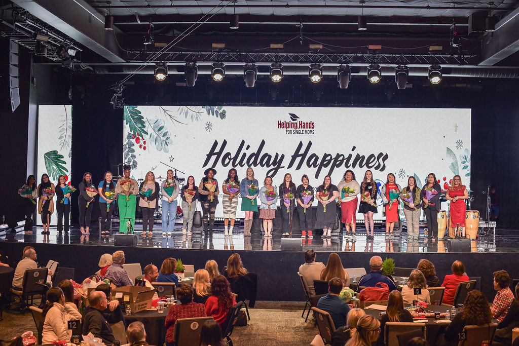 Photo of Single Moms on stage at 2024 Holiday Happiness event